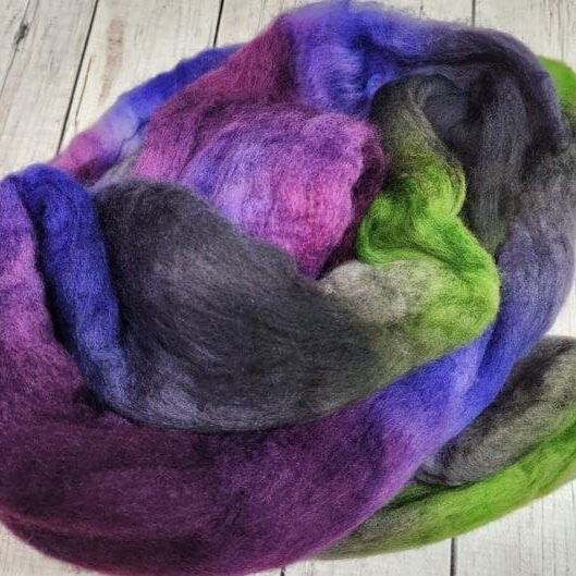 Purple, green, and blue wool roving.