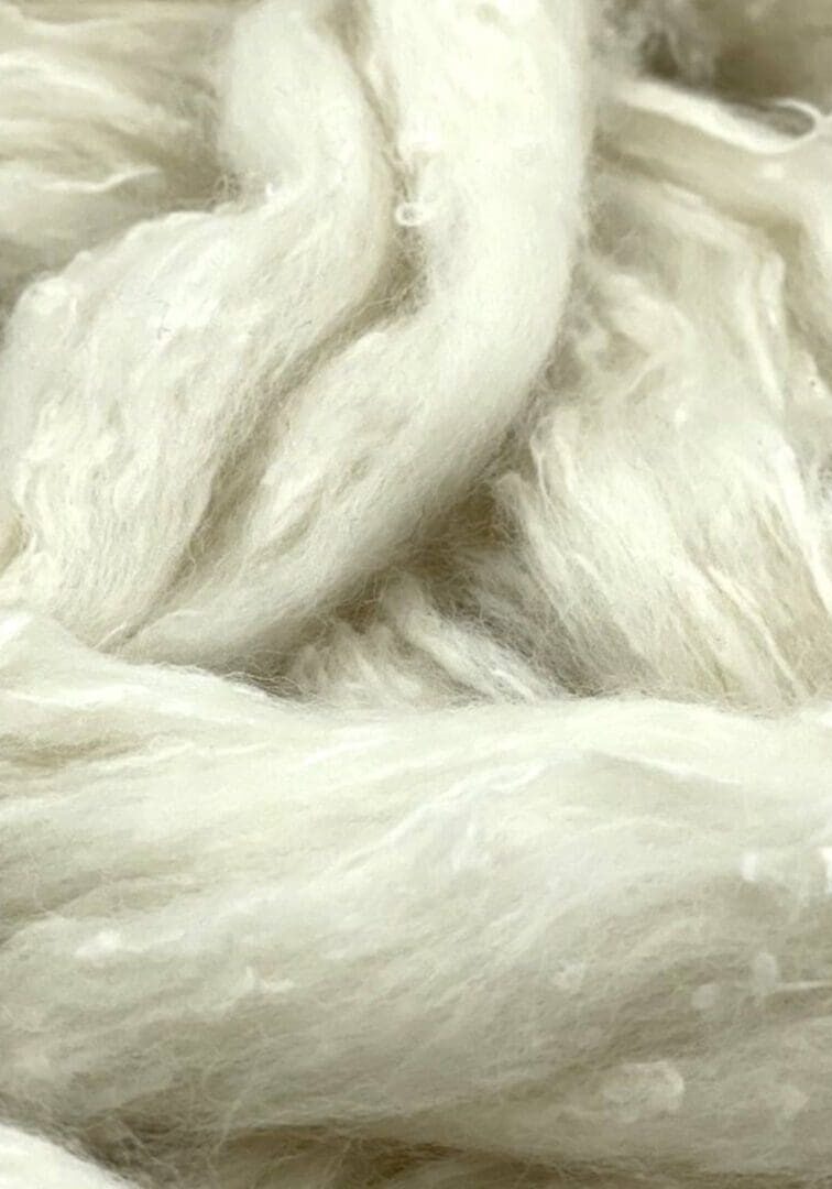A close up of a white yarn.
